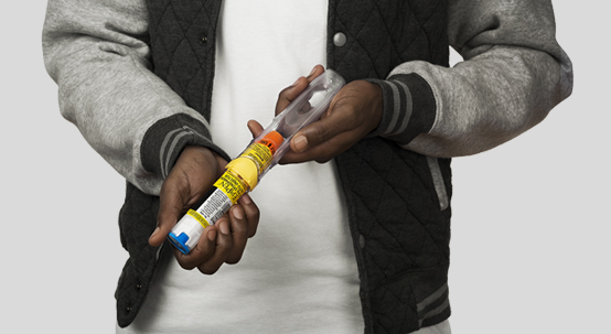Person holding auto injector