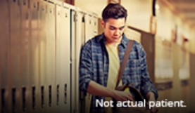 Boy putting an item in his school bag