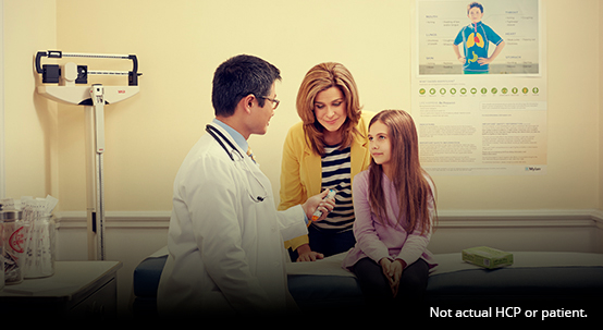 Doctor, young girl, and adult woman in exam room